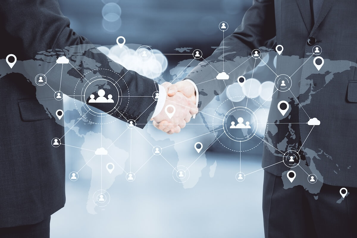 Two businessmen shaking hands behind a graphic that visualizes a marketing plan