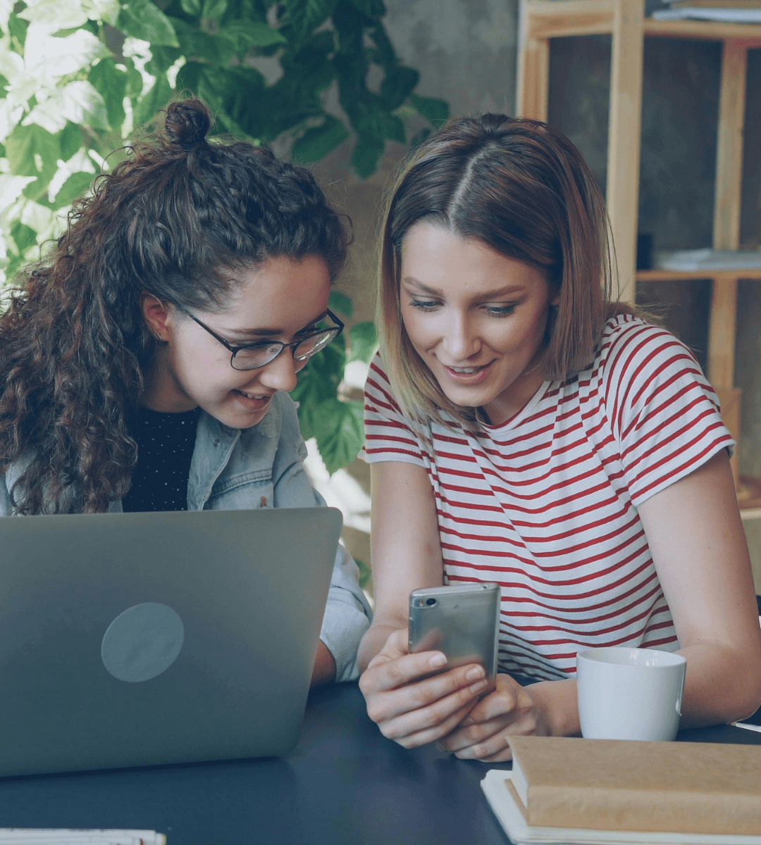 Two young girls looking at a retargeted ad on a mobile phone