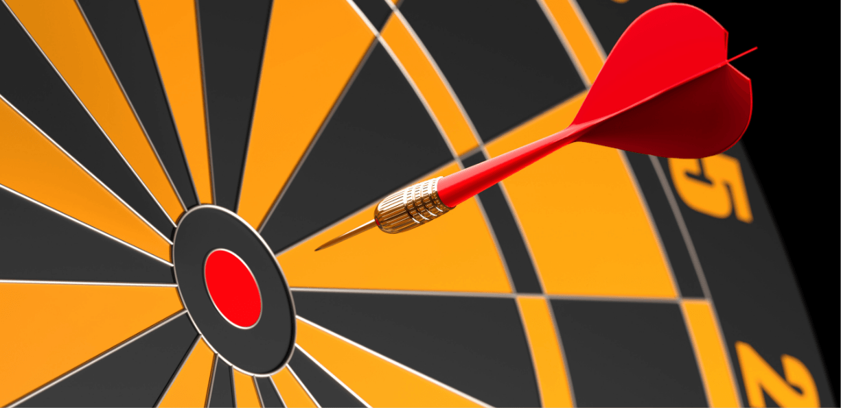 Dart hitting the center target on a dartboard