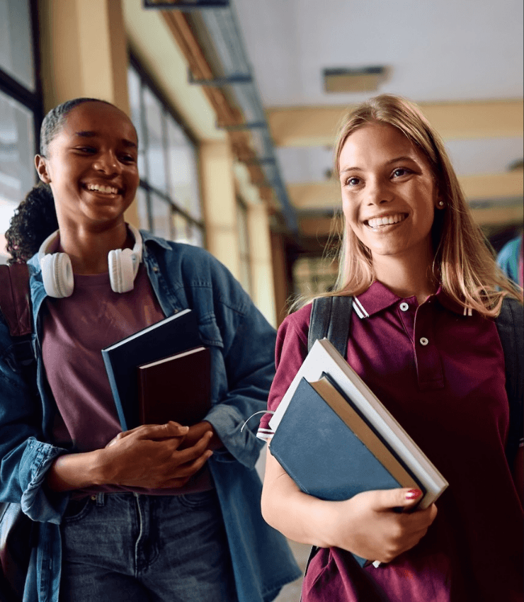 happy highschool students walking through school hallway