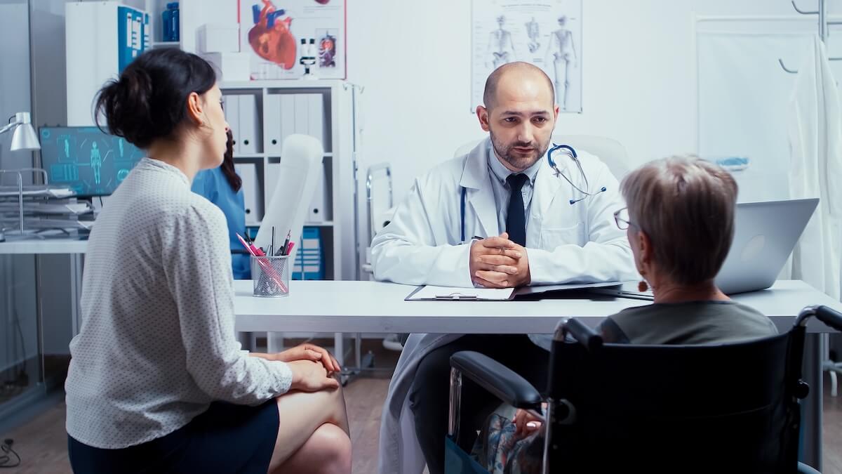 doctor in medical practice speaking with patients