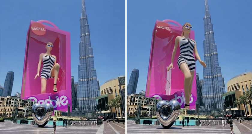 CGI image of a sky-scraper sized barbie doll walking out of her package in the middle of a city.