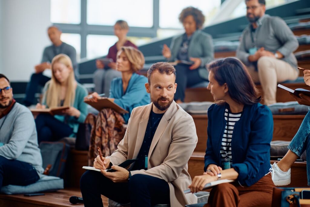 University faculty and staff participating in a collaborative seminar, representing higher education marketing strategies focused on enrollment, student engagement, and institutional growth.
