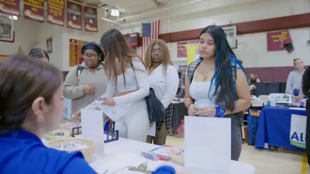 Students at a campus event table, from an LO Media college video shoot